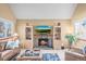 Comfortable living room with a brick fireplace, cozy couches, and large windows at 10588 E Park Mtn, Littleton, CO 80127