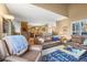 Open-concept living space featuring a fireplace, staircase, and lots of natural light at 10588 E Park Mtn, Littleton, CO 80127