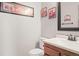 Neat half bathroom with a clean vanity and tasteful wall decor at 10588 E Park Mtn, Littleton, CO 80127