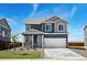 Charming two-story home with a two car garage, stone accents and a well manicured lawn at 2233 Base St, Fort Lupton, CO 80621