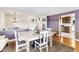 Open dining area with a rustic table and chairs, and a view to the kitchen at 10489 Quivas St, Northglenn, CO 80234