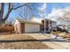 Brick ranch house with attached garage and landscaping at 10489 Quivas St, Northglenn, CO 80234