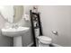 Cozy half bathroom featuring a pedestal sink and decorative ladder shelf at 5187 S Fairplay St, Aurora, CO 80015