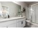 Bathroom featuring double sinks, granite countertop, and glass shower at 5187 S Fairplay St, Aurora, CO 80015