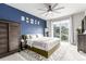Bright bedroom with a large bed, balcony, and decorative wall art at 5187 S Fairplay St, Aurora, CO 80015