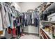 Walk-in closet with ample hanging space and shelving for shoes and accessories at 5187 S Fairplay St, Aurora, CO 80015
