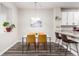 Cozy dining area with a white table set and modern light fixture at 5187 S Fairplay St, Aurora, CO 80015