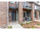 Inviting exterior showcases brick facade, welcoming front door, and a cozy patio area at 5187 S Fairplay St, Aurora, CO 80015
