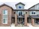 Charming townhouse with brick accents, second floor balcony, and covered patio at 5187 S Fairplay St, Aurora, CO 80015