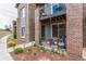 Charming townhome featuring a patio, second story balcony, and landscaped flower beds in front at 5187 S Fairplay St, Aurora, CO 80015