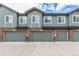 Townhome Exterior with Gray Siding and Brick Foundation at 5187 S Fairplay St, Aurora, CO 80015