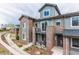 View of townhouses with brick accents, balconies, landscaping and private entrances at 5187 S Fairplay St, Aurora, CO 80015