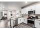 Open kitchen and dining area featuring stainless steel appliances and granite countertops at 5187 S Fairplay St, Aurora, CO 80015