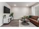 Comfortable living room area with a modern entertainment center and stylish decor at 5187 S Fairplay St, Aurora, CO 80015