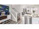 Stylish living space with staircase, modern decor, and stainless steel dishwasher at 5187 S Fairplay St, Aurora, CO 80015
