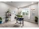 Bright home office with a whiteboard, plants, and natural light at 5187 S Fairplay St, Aurora, CO 80015