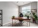 Bright home office featuring a large window, modern desk, and comfortable seating at 5187 S Fairplay St, Aurora, CO 80015