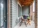 Cozy outdoor patio with seating, a grill, and a wood planked ceiling with string lights at 5187 S Fairplay St, Aurora, CO 80015
