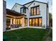 Two-story home with white brick exterior, black windows, and backyard patio at 673 S Gaylord St, Denver, CO 80209