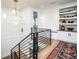 Stylish stairwell with metal railing and built-in shelving at 673 S Gaylord St, Denver, CO 80209