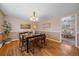 Dining room featuring hardwood floors, modern decor, and ample natural light at 6940 S Uinta St, Centennial, CO 80112