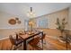 Bright dining room with hardwood floors, modern lighting, and a decorative wainscot at 6940 S Uinta St, Centennial, CO 80112
