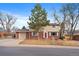 Charming two-story home with brick accents, a well-manicured lawn, and mature trees at 6940 S Uinta St, Centennial, CO 80112