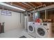 Basement laundry room with washer, dryer, and storage at 6940 S Uinta St, Centennial, CO 80112