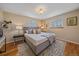 Serene main bedroom with neutral tones, a gray upholstered bed, and ample natural light at 6940 S Uinta St, Centennial, CO 80112