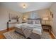 Comfortable main bedroom featuring a cozy gray bed, stylish decor, and natural light at 6940 S Uinta St, Centennial, CO 80112