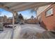 Cozy covered patio with snow-covered furniture, perfect for enjoying winter days outside at 6940 S Uinta St, Centennial, CO 80112