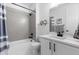 Bathroom featuring white cabinets, modern fixtures, tiled shower and tub at 27491 E 10Th Dr, Aurora, CO 80018