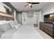 Bedroom with decorative headboard, beside tables, and barn-door access to ensuite bath at 27491 E 10Th Dr, Aurora, CO 80018