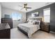 Bedroom with a ceiling fan, decorative headboard, and plush bedding at 27491 E 10Th Dr, Aurora, CO 80018