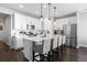 Bright, modern kitchen featuring white cabinetry, stainless steel appliances, and a large center island at 27491 E 10Th Dr, Aurora, CO 80018