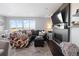 Cozy living room with a large sectional sofa, decorative fireplace, and ample natural light at 27491 E 10Th Dr, Aurora, CO 80018