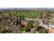 Charming property near a golf course, set against a backdrop of city skyline and majestic mountains at 2591 Albion St, Denver, CO 80207