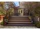 Wooden deck with outdoor seating surrounded by mature trees and greenery, with a spiral staircase at 2591 Albion St, Denver, CO 80207