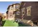 Spacious backyard featuring artificial turf and brick architecture at 2591 Albion St, Denver, CO 80207