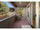 Balcony with brick floors featuring hanging plants and a covered space for outdoor enjoyment and relaxation at 2591 Albion St, Denver, CO 80207