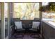 Charming balcony features comfortable seating with pillows, offering a relaxing outdoor space with scenic views at 2591 Albion St, Denver, CO 80207