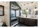 Modern bathroom with tiled shower, dual vanity, and contemporary fixtures at 2591 Albion St, Denver, CO 80207