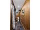 Rustic bathroom with wood paneling, slate tile, and shower at 2591 Albion St, Denver, CO 80207