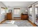 Bedroom featuring hardwood floors, neutral walls, and a sliding door to the outside with two dressers next to it at 2591 Albion St, Denver, CO 80207
