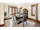 Bright dining room featuring hardwood floors, a large table with seating, and natural light from ample windows at 2591 Albion St, Denver, CO 80207