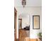 Inviting hallway with hardwood floors, arched doorways, and a view into a sunlit room at 2591 Albion St, Denver, CO 80207