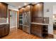 Well-equipped kitchen with stainless steel appliances, dark wood cabinets, and hardwood flooring at 2591 Albion St, Denver, CO 80207
