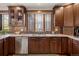 Kitchen featuring stainless steel appliances, granite countertops, mosaic tile backsplash, and wooden cabinets at 2591 Albion St, Denver, CO 80207