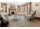 Inviting living room with a brick fireplace, hardwood floors, large windows, and comfortable seating area at 2591 Albion St, Denver, CO 80207