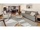 Open-concept living room with modern furnishings and seamless flow into the kitchen and dining area at 2591 Albion St, Denver, CO 80207